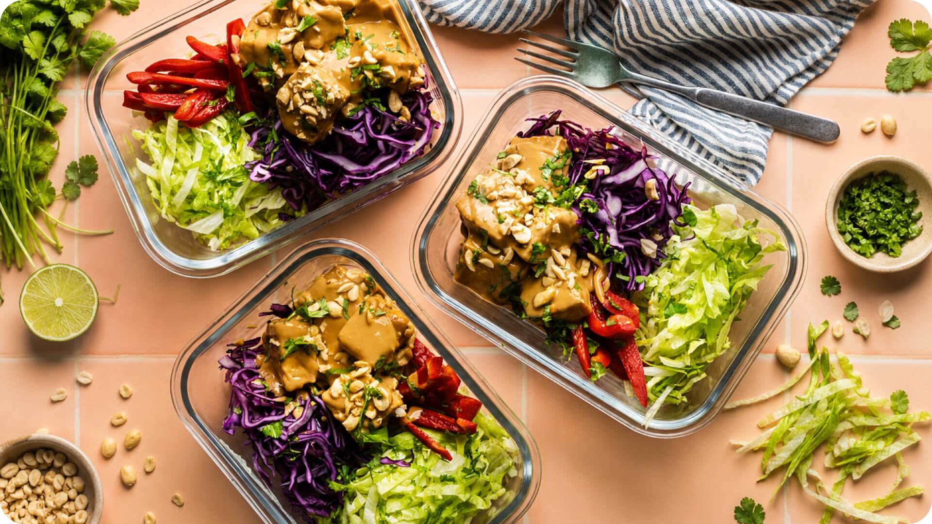 Meal prep bowls with chicken, red peppers, cabbage and rice noodles